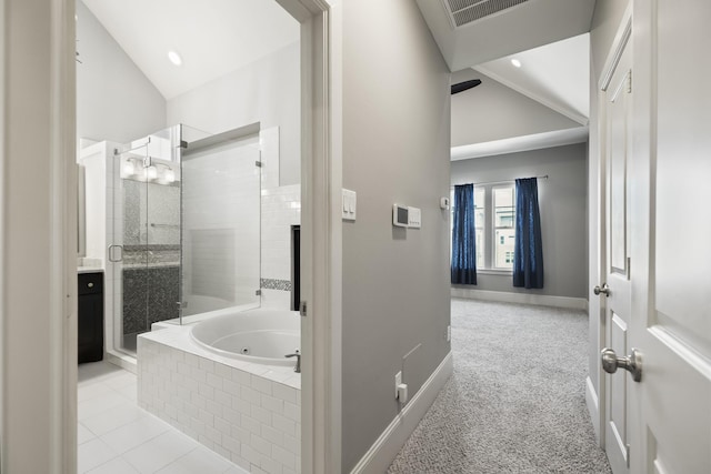 1407 Patterson St, Houston, TX 77007 - bathroom with vaulted ceiling, a tub with jets, a stall shower, and baseboards