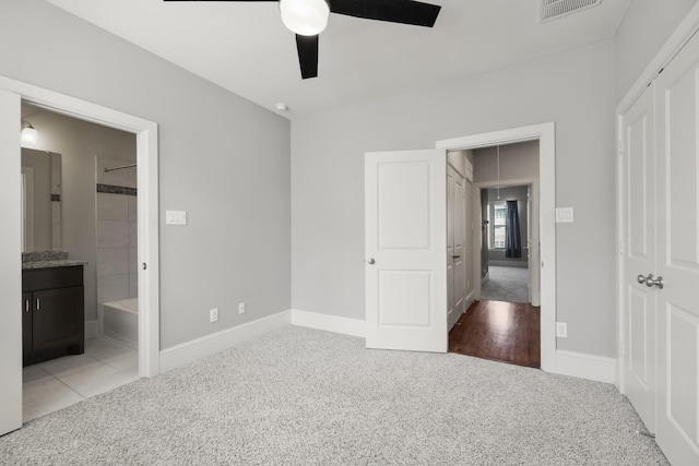1407 Patterson St, Houston, TX 77007 - unfurnished bedroom featuring carpet, baseboards, connected bathroom, and a ceiling fan