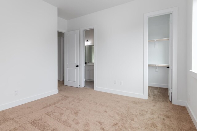 1411 E 34th St, Houston, TX 77022 - unfurnished bedroom featuring carpet, a spacious closet, and a closet
