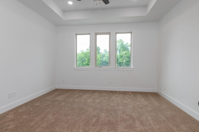 1411 E 34th St, Houston, TX 77022 - empty room featuring carpet flooring, a ceiling fan, a raised ceiling, baseboards, and recessed lighting