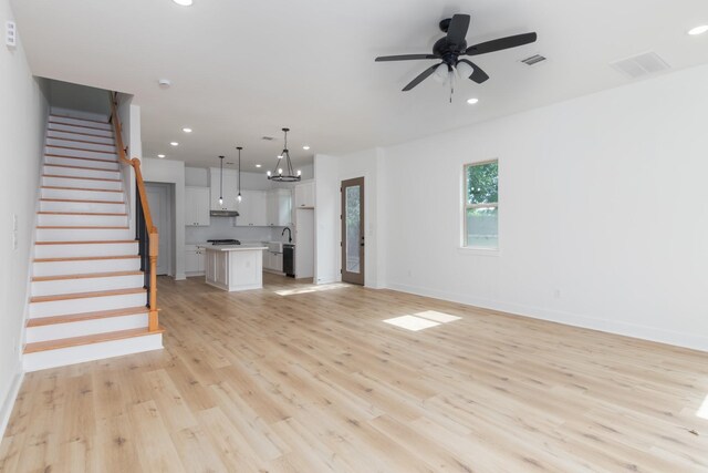 1411 E 34th St, Houston, TX 77022 - unfurnished living room with light wood-style floors, stairs, ceiling fan, recessed lighting, and baseboards