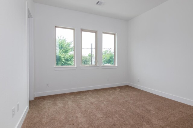 1411 E 34th St, Houston, TX 77022 - carpeted empty room featuring healthy amount of natural light and baseboards