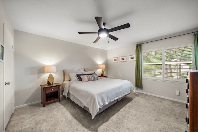 6417 Olympia Dr Unit 144, Houston, TX 77057 - bedroom with baseboards, light carpet, and ceiling fan