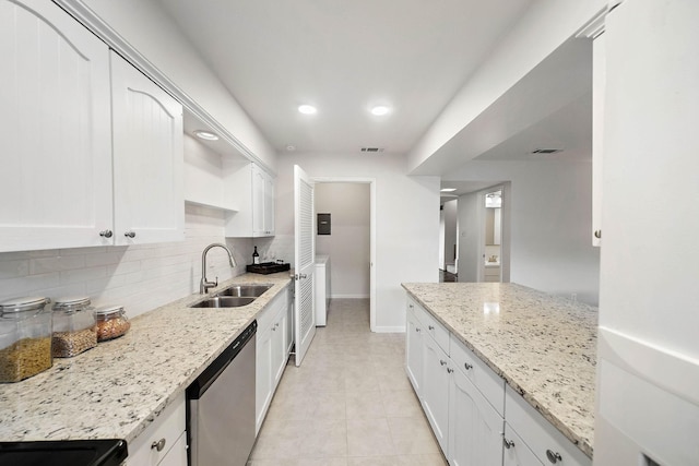 6417 Olympia Dr Unit 144, Houston, TX 77057 - kitchen featuring a sink, dishwasher, baseboards, backsplash, and white cabinets