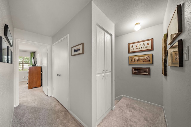 6417 Olympia Dr Unit 144, Houston, TX 77057 - hallway with light colored carpet and baseboards