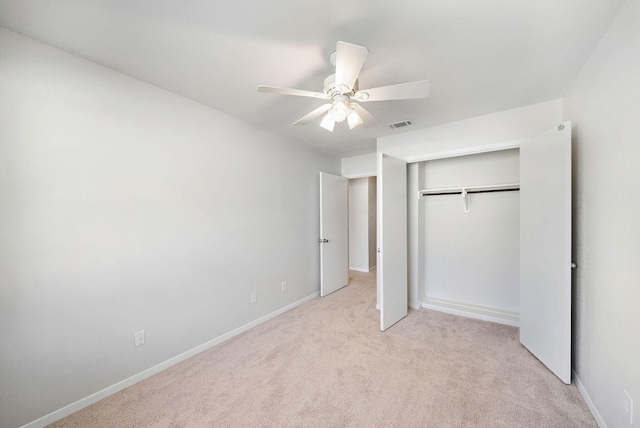 6417 Olympia Dr Unit 144, Houston, TX 77057 - unfurnished bedroom featuring light colored carpet, a closet, baseboards, and a ceiling fan