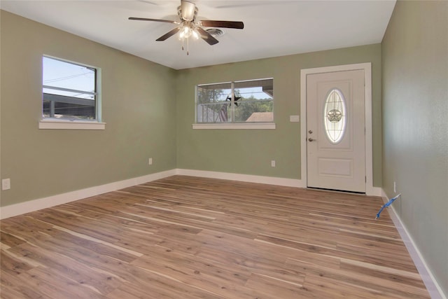 1105 W Dr, Port Neches, TX 77651 - entrance foyer with light wood finished floors, a ceiling fan, and baseboards