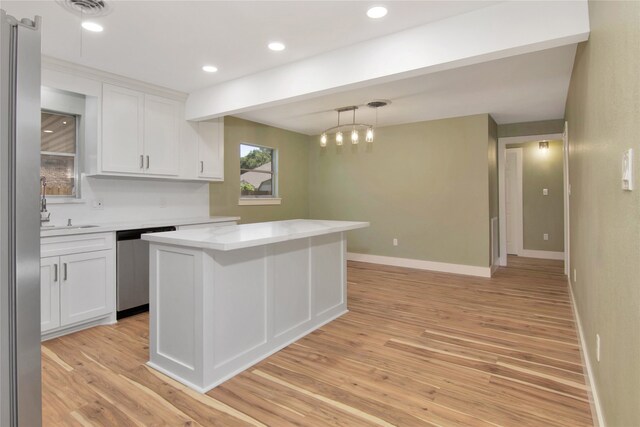 1105 W Dr, Port Neches, TX 77651 - kitchen featuring dishwasher, light countertops, light wood-style flooring, white cabinets, and recessed lighting