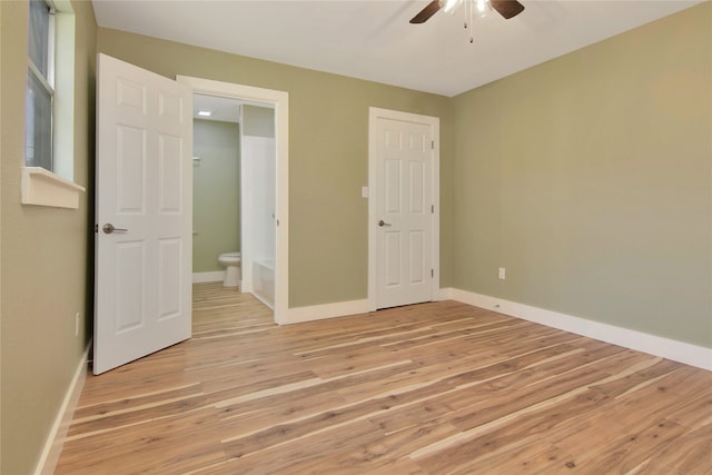 1105 W Dr, Port Neches, TX 77651 - unfurnished bedroom featuring light wood-type flooring, baseboards, and connected bathroom