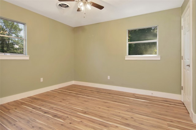 1105 W Dr, Port Neches, TX 77651 - unfurnished room featuring a ceiling fan, light wood finished floors, and baseboards