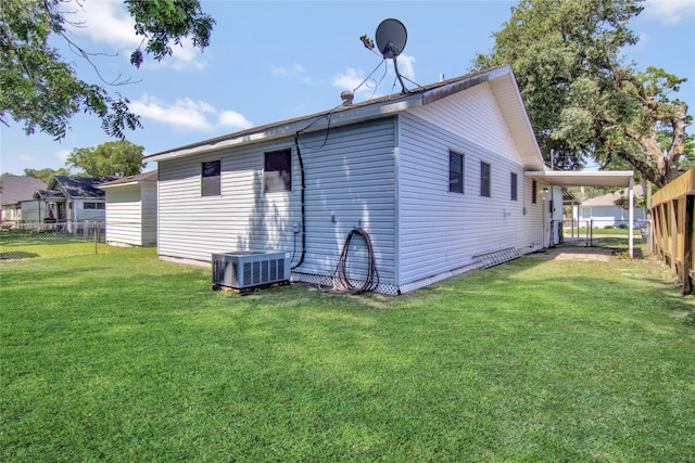 1105 W Dr, Port Neches, TX 77651 - back of house featuring a carport and central AC unit