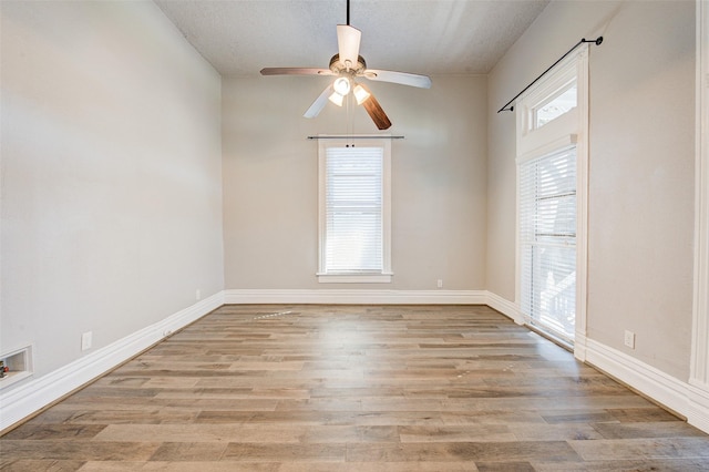 1318 Bingham St, Houston, TX 77007 - empty room with ceiling fan, wood finished floors, a textured ceiling, and baseboards