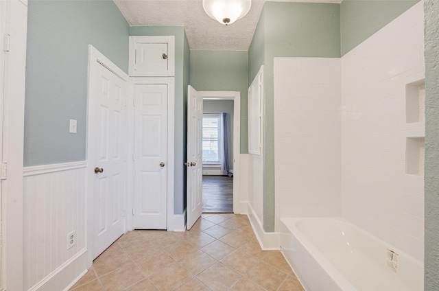 1318 Bingham St, Houston, TX 77007 - full bath with tile patterned floors, a textured ceiling, wainscoting, and baseboards