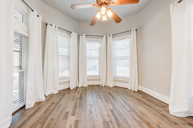 1318 Bingham St, Houston, TX 77007 - empty room featuring light wood-style floors, baseboards, a ceiling fan, and healthy amount of natural light
