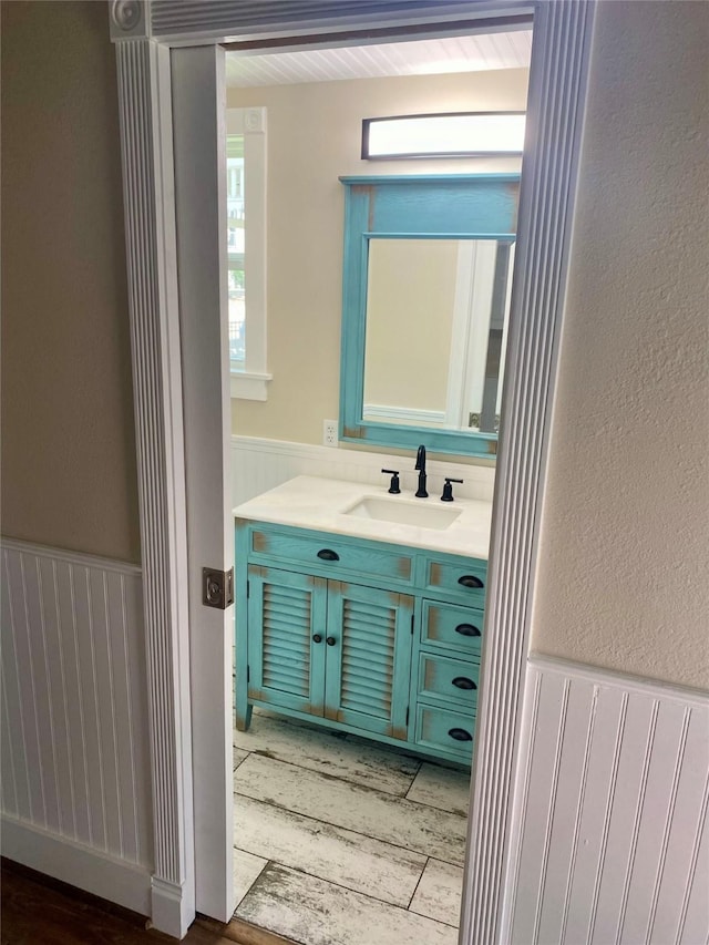 1318 Bingham St, Houston, TX 77007 - bathroom featuring a wainscoted wall, vanity, and wood finished floors