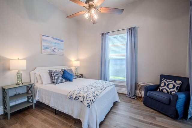 1318 Bingham St, Houston, TX 77007 - bedroom featuring wood finished floors, multiple windows, and a ceiling fan