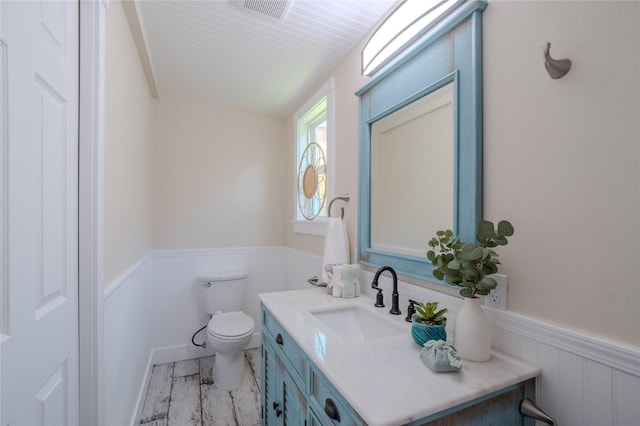 1318 Bingham St, Houston, TX 77007 - half bathroom featuring toilet, wainscoting, and vanity