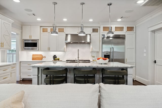1409 Tulane St, Houston, TX 77008 - kitchen with built in appliances, exhaust hood, a sink, decorative backsplash, and a breakfast bar area