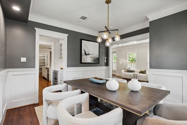 1409 Tulane St, Houston, TX 77008 - dining space featuring beverage cooler, wainscoting, dark wood-style flooring, crown molding, and a decorative wall