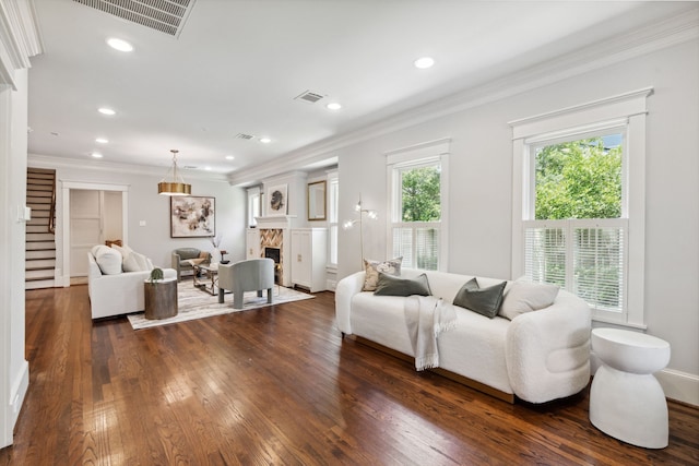 1409 Tulane St, Houston, TX 77008 - living room featuring dark wood-type flooring, a fireplace, ornamental molding, recessed lighting, and stairs