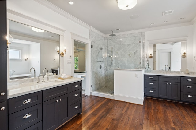 1409 Tulane St, Houston, TX 77008 - full bath featuring a shower stall, two vanities, plenty of natural light, crown molding, and wood finished floors
