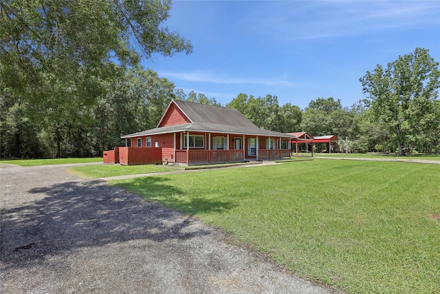 517 Hillebrandt, Beaumont, TX 77705 - farmhouse-style home featuring a porch, a front lawn, and gravel driveway