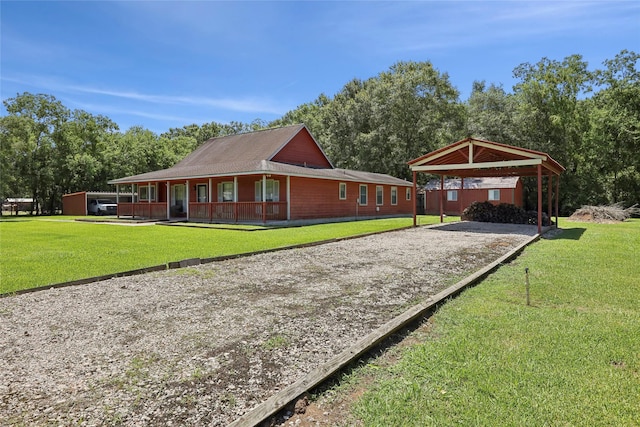 517 Hillebrandt, Beaumont, TX 77705 - view of front of property featuring driveway, a front yard, a porch, and a detached carport