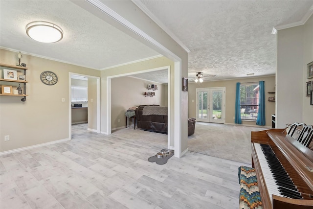 517 Hillebrandt, Beaumont, TX 77705 - corridor featuring a textured ceiling, crown molding, french doors, light wood-style floors, and baseboards