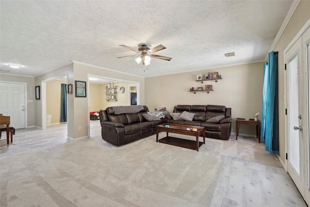 517 Hillebrandt, Beaumont, TX 77705 - living area featuring a ceiling fan, ornamental molding, baseboards, and a textured ceiling