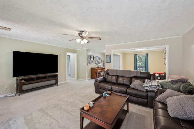 517 Hillebrandt, Beaumont, TX 77705 - living area featuring a ceiling fan, a textured ceiling, light colored carpet, baseboards, and crown molding