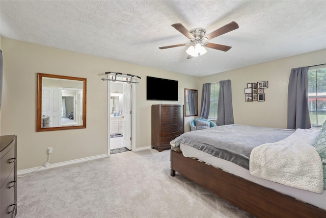 517 Hillebrandt, Beaumont, TX 77705 - bedroom with baseboards, light colored carpet, a textured ceiling, ensuite bath, and ceiling fan