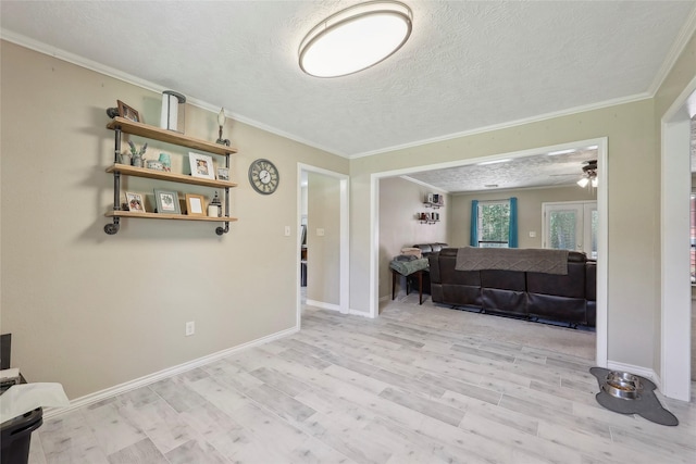 517 Hillebrandt, Beaumont, TX 77705 - living room with crown molding, a textured ceiling, wood finished floors, a ceiling fan, and baseboards