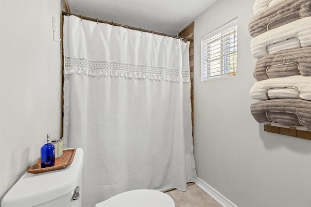 110 N Willis St, Lampasas, TX 76550 - full bath with toilet, tile patterned flooring, curtained shower, and baseboards
