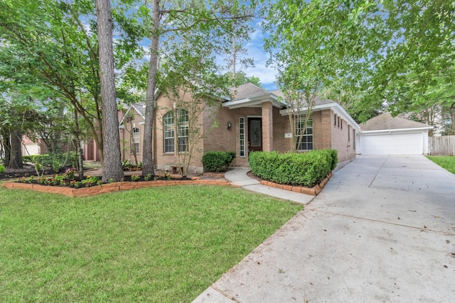 19 Long Springs Pl, The Woodlands, TX 77382 - view of front of home featuring brick siding, a front lawn, a garage, and an outdoor structure