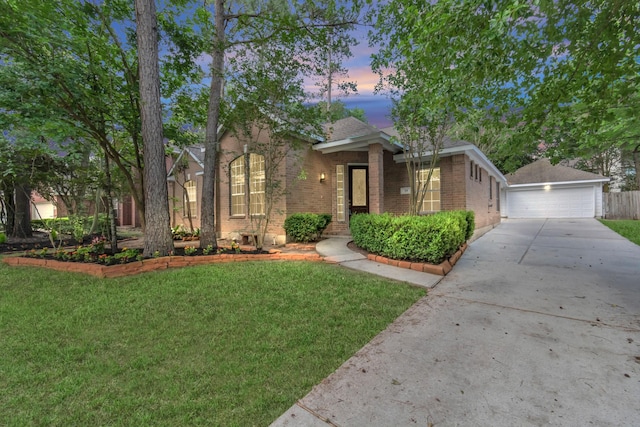 19 Long Springs Pl, The Woodlands, TX 77382 - view of front of property with brick siding, a lawn, a detached garage, and an outbuilding