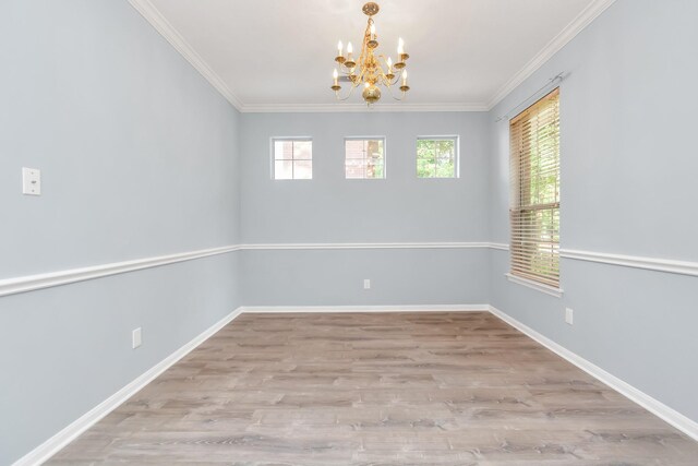 19 Long Springs Pl, The Woodlands, TX 77382 - unfurnished room featuring a chandelier, wood finished floors, crown molding, and baseboards