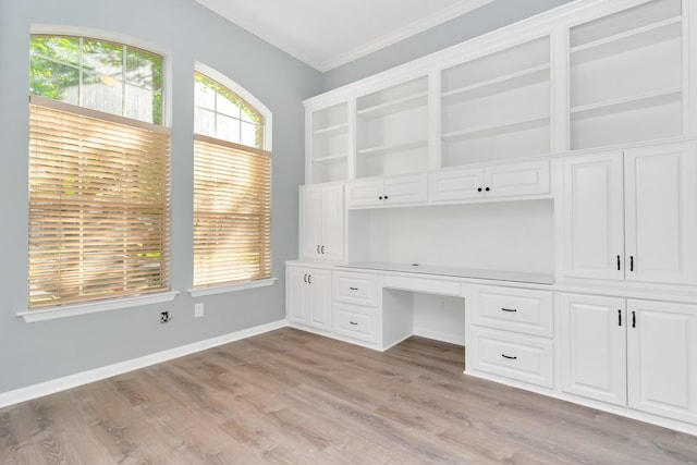 19 Long Springs Pl, The Woodlands, TX 77382 - unfurnished office with crown molding, light wood-style flooring, built in desk, and baseboards
