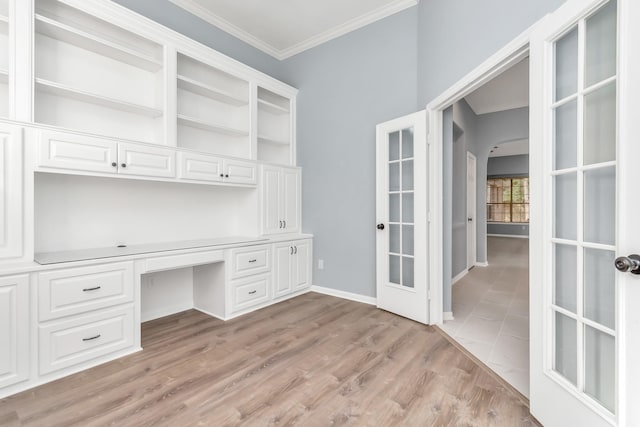 19 Long Springs Pl, The Woodlands, TX 77382 - unfurnished office with arched walkways, ornamental molding, french doors, built in study area, and light wood-type flooring