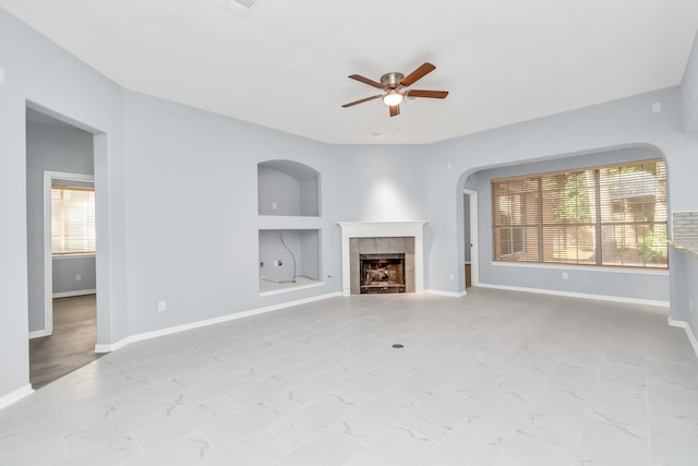 19 Long Springs Pl, The Woodlands, TX 77382 - unfurnished living room with a ceiling fan, a fireplace, healthy amount of natural light, and baseboards