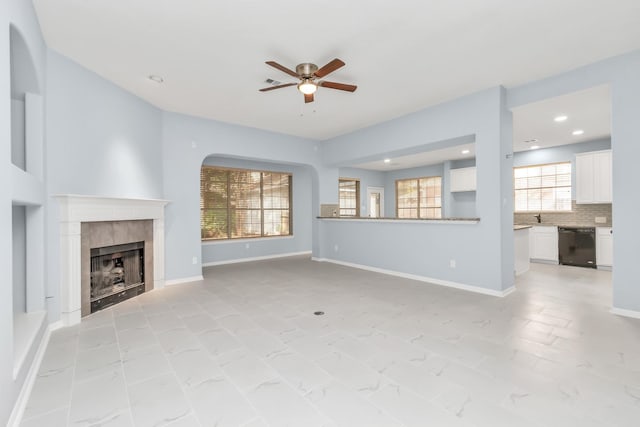 19 Long Springs Pl, The Woodlands, TX 77382 - unfurnished living room featuring a ceiling fan, a tiled fireplace, recessed lighting, and baseboards