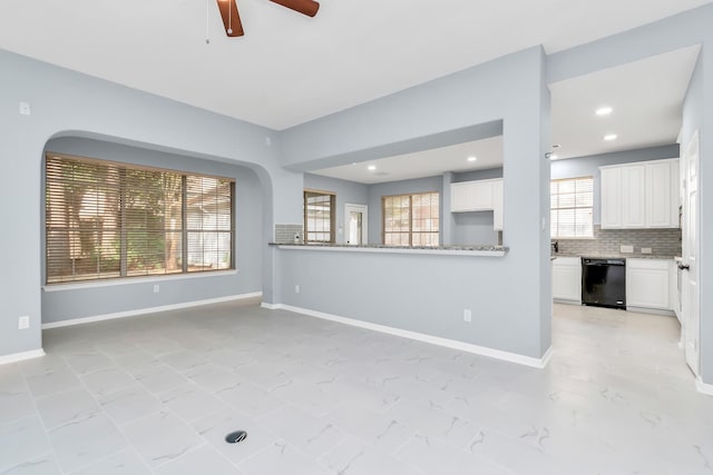 19 Long Springs Pl, The Woodlands, TX 77382 - unfurnished living room with ceiling fan, baseboards, light marble finish floors, and recessed lighting