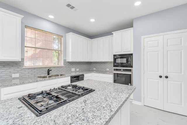 19 Long Springs Pl, The Woodlands, TX 77382 - kitchen featuring black appliances, a sink, white cabinets, and recessed lighting
