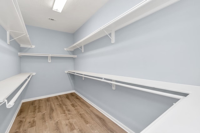 19 Long Springs Pl, The Woodlands, TX 77382 - walk in closet featuring wood finished floors