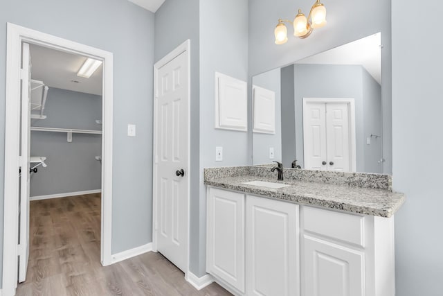 19 Long Springs Pl, The Woodlands, TX 77382 - bathroom featuring wood finished floors, vanity, a closet, and a chandelier