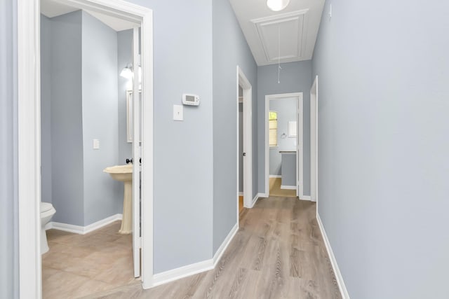 19 Long Springs Pl, The Woodlands, TX 77382 - hallway with attic access, baseboards, and light wood-type flooring