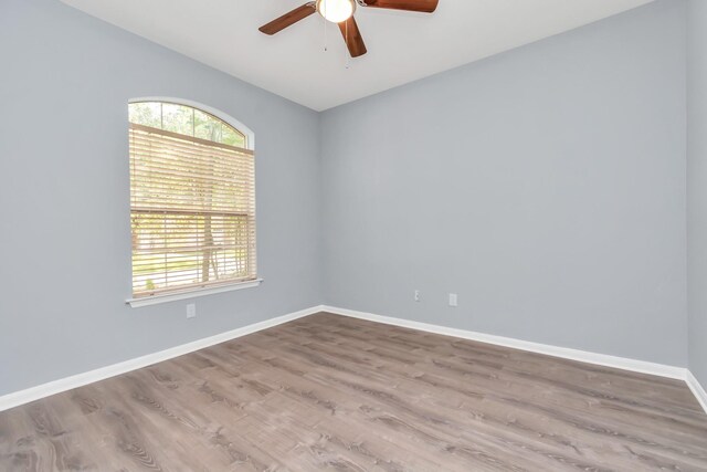 19 Long Springs Pl, The Woodlands, TX 77382 - empty room featuring a ceiling fan, baseboards, and wood finished floors