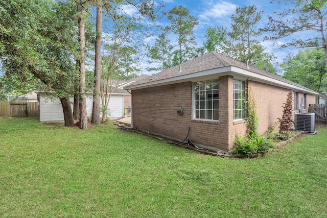 19 Long Springs Pl, The Woodlands, TX 77382 - view of home's exterior featuring central air condition unit, brick siding, and roof with shingles