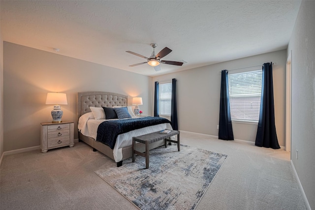2923 Laurel Mill Way, Houston, TX 77080 - bedroom with light colored carpet, a ceiling fan, baseboards, and a textured ceiling