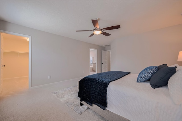 2923 Laurel Mill Way, Houston, TX 77080 - bedroom featuring carpet, a spacious closet, a ceiling fan, baseboards, and connected bathroom