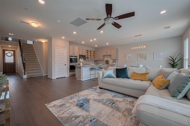 2923 Laurel Mill Way, Houston, TX 77080 - living room with ceiling fan, stairs, dark wood-style flooring, recessed lighting, and a chandelier